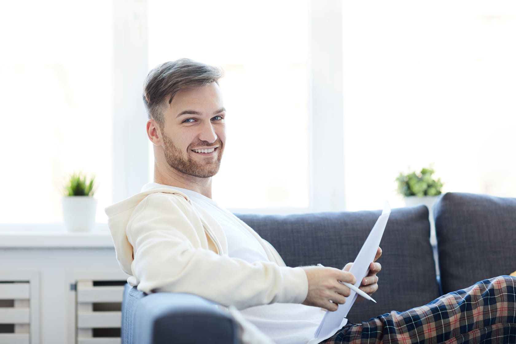 Mies tarkastelee sähkölaskua tyytyväisenä – positiivisia Väre kokemuksia säästöistä 2026